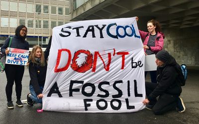 Protesters with banners reading ‘Stay cool, don’t be a fossil fool’ and ‘Keep calm and divest.’