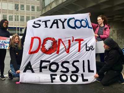 Protesters with banners reading ‘Stay cool, don’t be a fossil fool’ and ‘Keep calm and divest.’