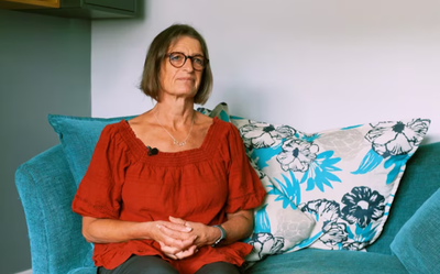 Anne sitting in her living room.