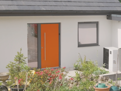Exterior of a home looking at front door with heat pump