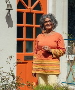 Sofia standing in front of her home.