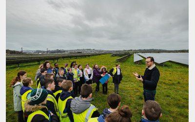 School children listening to their teacher at Ernesettle solar farm.