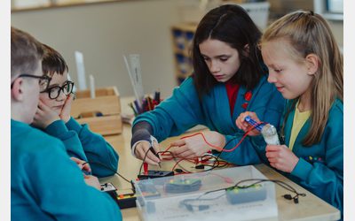 School children working with solar electricity kits during a group project.